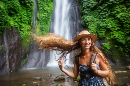 Woman near Munduk waterfal on Bali, Indonesiaの写真素材