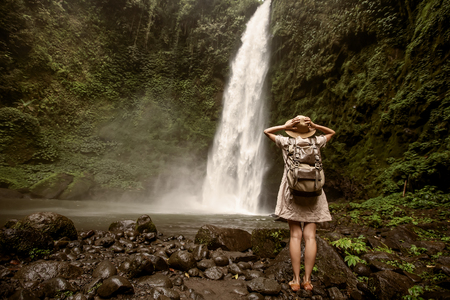 Woman near Nung Nung waterfal on Bali, Indonesiaの写真素材