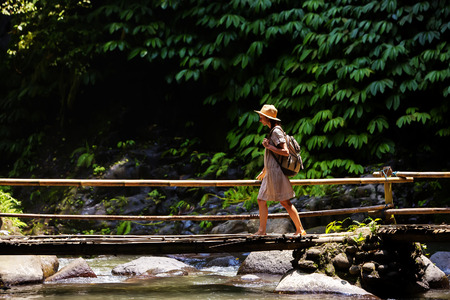 Woman near Nung Nung waterfal on Bali, Indonesiaの写真素材