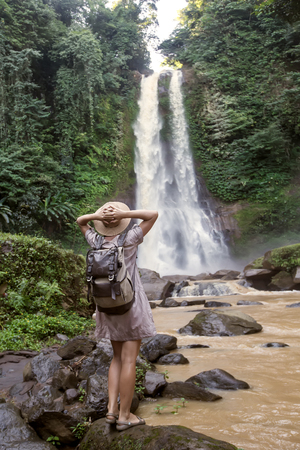 Woman near waterfal Git Git on Bali, IndonesiaÂ の写真素材