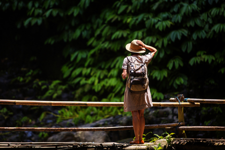 Woman near Nung Nung waterfal on Bali, Indonesiaの写真素材