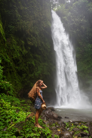 Woman near Nung Nung waterfal on Bali, Indonesiaの写真素材