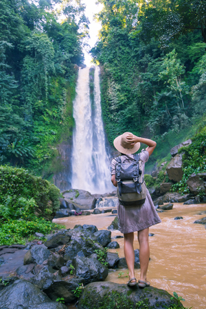 Woman near waterfal Git Git on Bali, IndonesiaÂ の写真素材