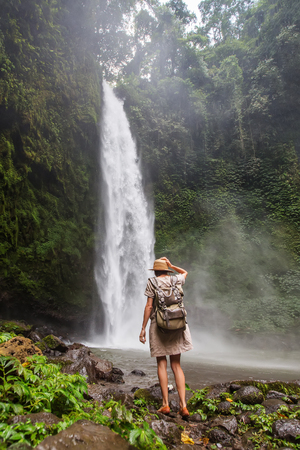 Woman near Nung Nung waterfal on Bali, Indonesiaの写真素材