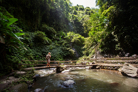Woman near Nung Nung waterfal on Bali, Indonesiaの写真素材