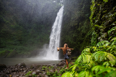 Woman near Nung Nung waterfal on Bali, Indonesiaの写真素材