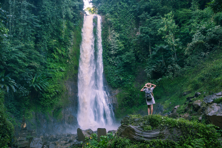 Woman near waterfal Git Git on Bali, IndonesiaÂ の写真素材