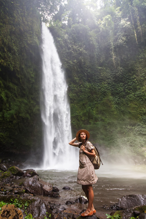 Woman near Nung Nung waterfal on Bali, Indonesiaの写真素材