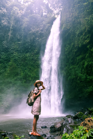 Woman near Nung Nung waterfal on Bali, Indonesiaの写真素材