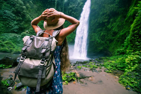 Woman near Nung Nung waterfal on Bali, Indonesiaの写真素材