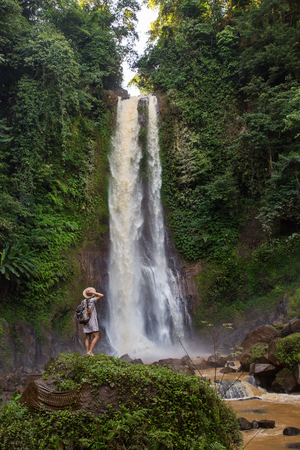 Woman near waterfal Git Git on Bali, IndonesiaÂ の写真素材