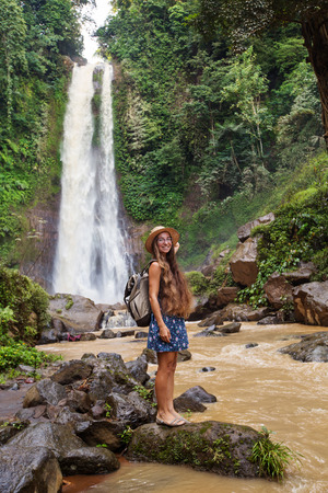 Woman near waterfal Git Git on Bali, IndonesiaÂ の写真素材
