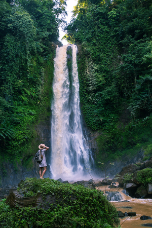 Woman near waterfal Git Git on Bali, IndonesiaÂ の写真素材