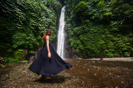 Woman near waterfal on Bali, IndonesiaÂ の写真素材