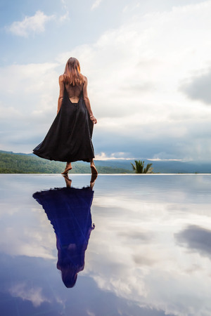 Beautiful woman by the poolの写真素材