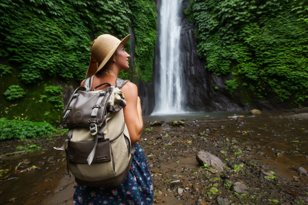 Woman near Munduk waterfal on Bali, Indonesiaの写真素材