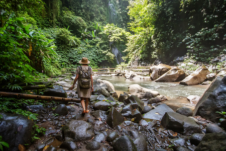 Woman near Nung Nung waterfal on Bali, Indonesiaの写真素材