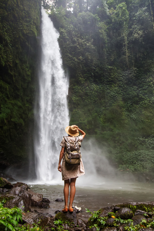 Woman near Nung Nung waterfal on Bali, Indonesiaの写真素材