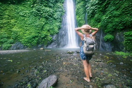 Woman near Munduk waterfal on Bali, Indonesiaの写真素材