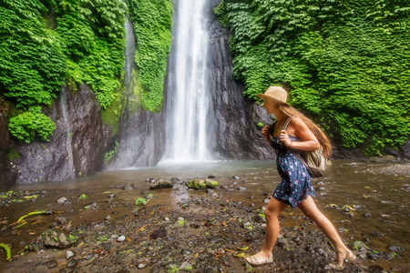 Woman near Munduk waterfal on Bali, Indonesiaの写真素材