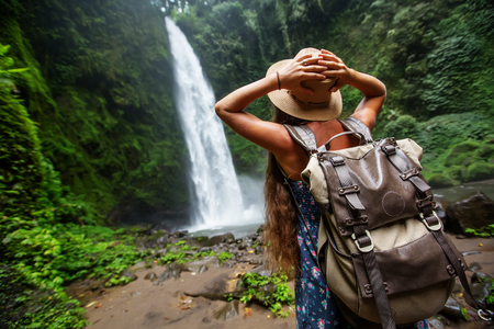 Woman near Nung Nung waterfal on Bali, Indonesiaの写真素材