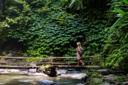 Woman near Nung Nung waterfal on Bali, Indonesiaの写真素材