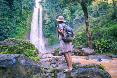 Woman near waterfal Git Git on Bali, IndonesiaÂ の写真素材