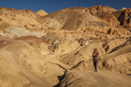 A hiker in the Artist`s Palette landmark place in Death Valley National Park, Geology, sand.の写真素材