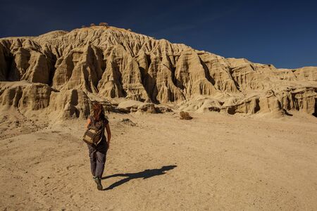 A hiker in the Artist`s Palette landmark place in Death Valley National Park, Geology, sand.の写真素材