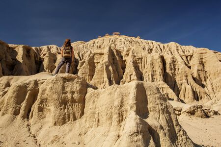 A hiker in the Artist`s Palette landmark place in Death Valley National Park, Geology, sand.の写真素材