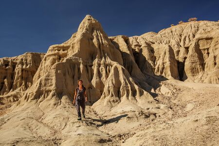 A hiker in the Artist`s Palette landmark place in Death Valley National Park, Geology, sand.の写真素材