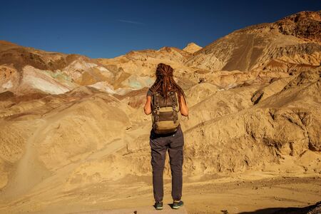 A hiker in the Artist`s Palette landmark place in Death Valley National Park, Geology, sand.の写真素材