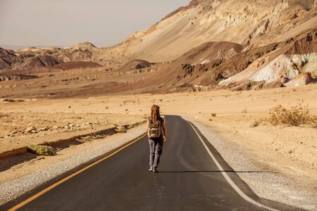 hitchhiker woman walking on a road in USAの写真素材