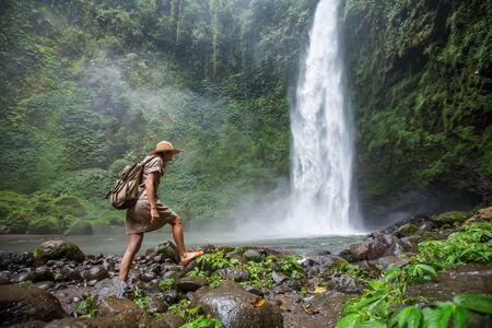 Woman near Nung Nung waterfal on Bali, Indonesiaの写真素材