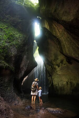 Mother with son near waterfal on Bali, IndonesiaÂ の写真素材