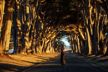 Happy girl in a tunnel with treesの写真素材
