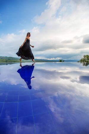 Beautiful woman by the poolの写真素材
