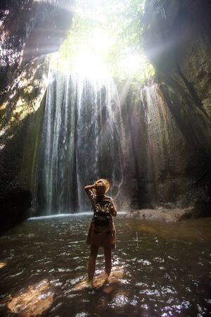 Woman near waterfal on Bali, IndonesiaÂ の写真素材