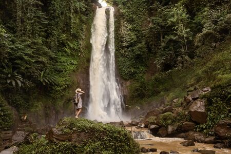 Woman near waterfal Git Git on Bali, IndonesiaÂ の写真素材