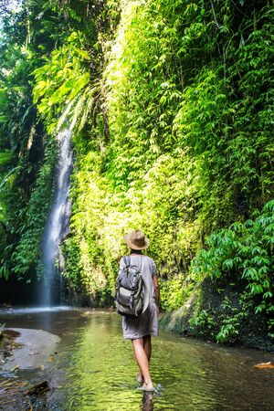 Woman near waterfal on Bali, IndonesiaÂ の写真素材