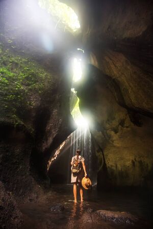 Woman near waterfal on Bali, IndonesiaÂ の写真素材