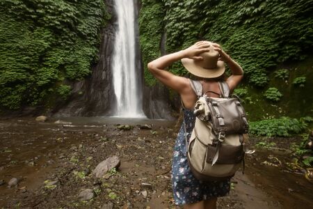 Woman near Munduk waterfal on Bali, Indonesiaの写真素材