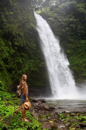 Woman near Nung Nung waterfal on Bali, Indonesiaの写真素材