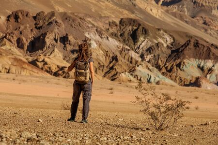 A hiker in the Artist`s Palette landmark place in Death Valley National Park, Geology, sand.の写真素材