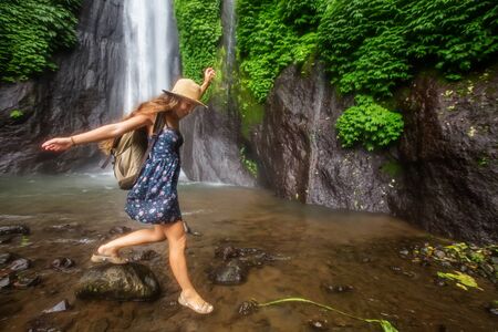 Woman near Munduk waterfal on Bali, Indonesiaの写真素材