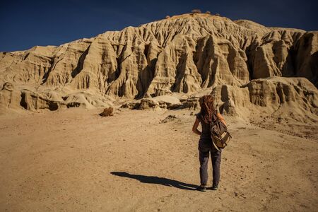 A hiker in the Artist`s Palette landmark place in Death Valley National Park, Geology, sand.の写真素材