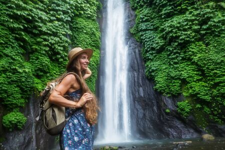 Woman near Munduk waterfal on Bali, Indonesiaの写真素材