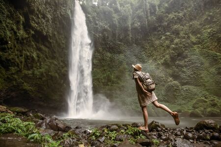 Woman near Nung Nung waterfal on Bali, Indonesiaの写真素材