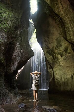 Woman near waterfal on Bali, IndonesiaÂ の写真素材