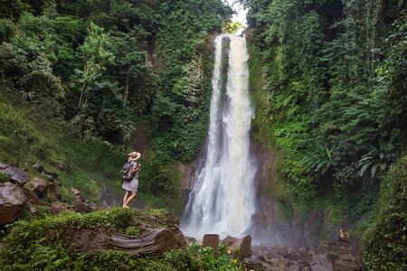Woman near waterfal Git Git on Bali, IndonesiaÂ の写真素材